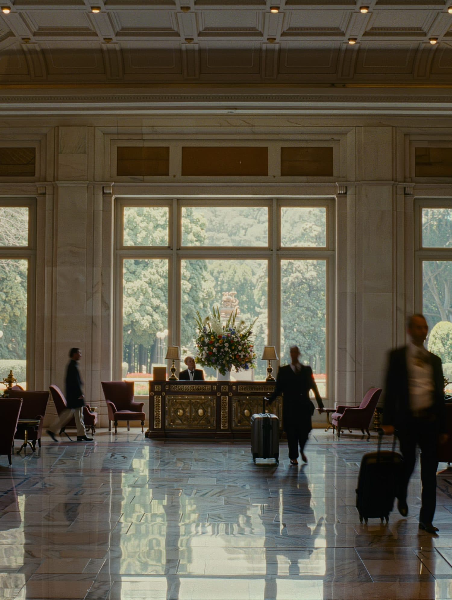 A hotel lobby with guests and luggage blurred in motion